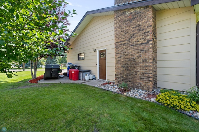 21 35th Ave NE, Fargo, ND 58102 - view of side of home with a lawn and brick siding