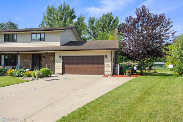 21 35th Ave NE, Fargo, ND 58102 - view of front facade featuring an attached garage, a front yard, driveway, a chimney, and brick siding