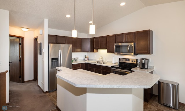 34 Cedar Dr, Mapleton, ND 58059 - kitchen with appliances with stainless steel finishes, light countertops, dark brown cabinetry, vaulted ceiling, and hanging light fixtures