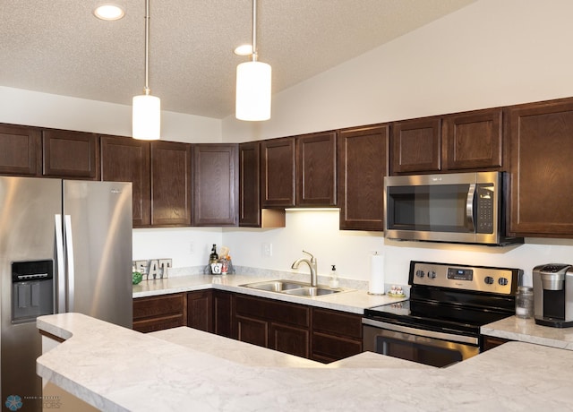 34 Cedar Dr, Mapleton, ND 58059 - kitchen featuring stainless steel appliances, dark brown cabinets, light countertops, a textured ceiling, and recessed lighting