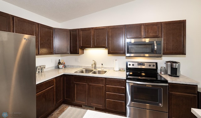 34 Cedar Dr, Mapleton, ND 58059 - kitchen with stainless steel appliances, light countertops, dark brown cabinetry, light tile patterned floors, and a textured ceiling