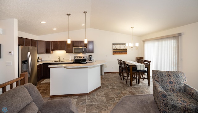 34 Cedar Dr, Mapleton, ND 58059 - kitchen with appliances with stainless steel finishes, dark brown cabinets, lofted ceiling, light countertops, and open floor plan