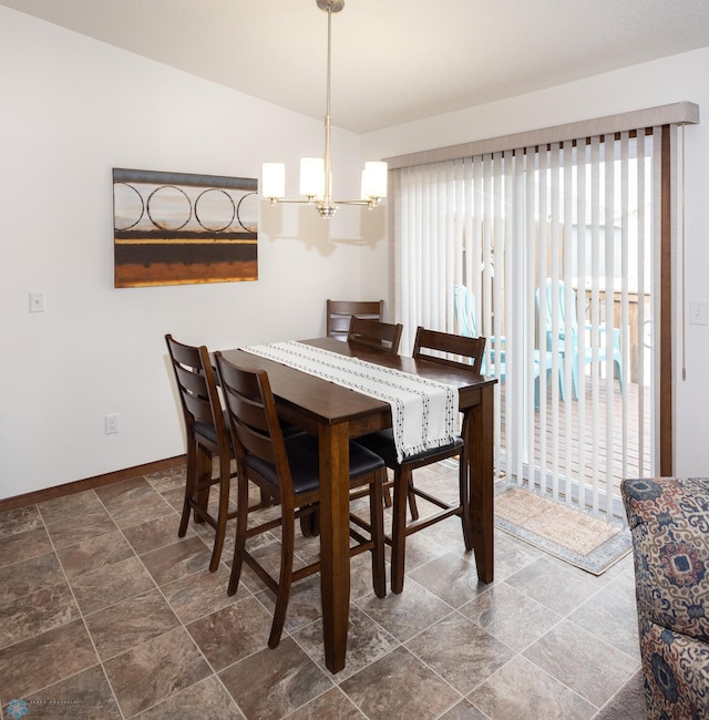 34 Cedar Dr, Mapleton, ND 58059 - dining room featuring plenty of natural light, a chandelier, lofted ceiling, and dark stone finish floors