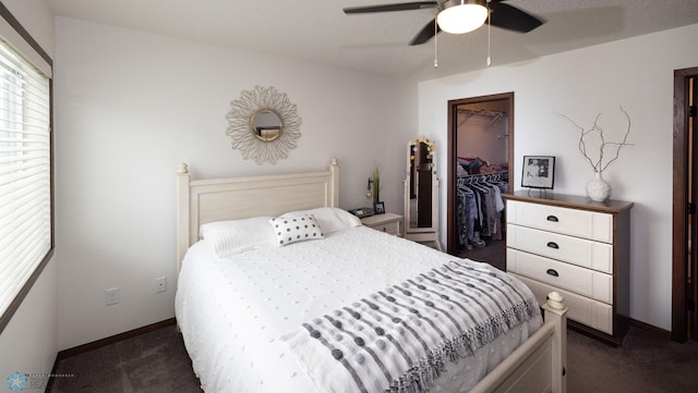 34 Cedar Dr, Mapleton, ND 58059 - bedroom with dark colored carpet, a spacious closet, a closet, and a ceiling fan