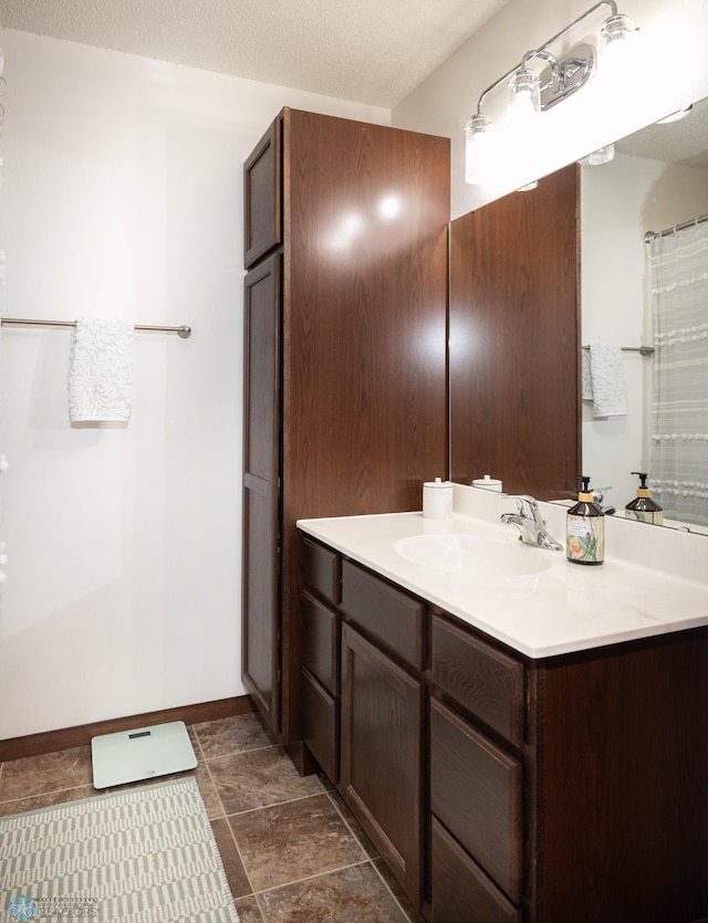 34 Cedar Dr, Mapleton, ND 58059 - bathroom featuring vanity, a textured ceiling, and stone finish floors