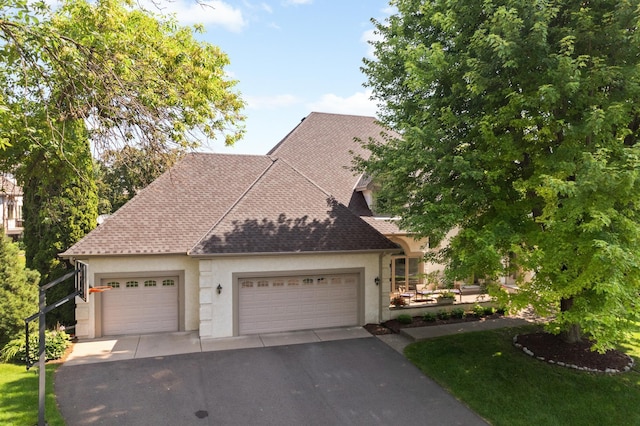 4803 Chantrey Pl, Minnetonka, MN 55345 - view of front of property with stucco siding, driveway, a garage, and a shingled roof