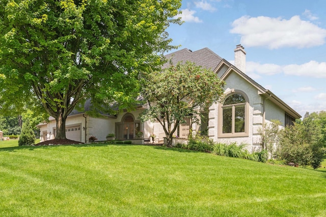 4803 Chantrey Pl, Minnetonka, MN 55345 - view of property hidden behind natural elements with a front yard, an attached garage, a chimney, and stucco siding