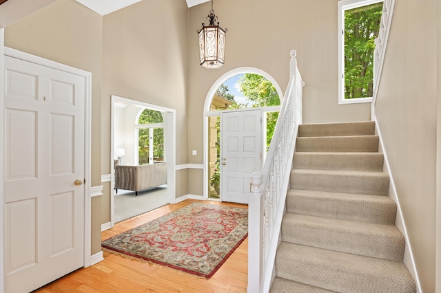 4803 Chantrey Pl, Minnetonka, MN 55345 - foyer entrance featuring healthy amount of natural light, wood finished floors, stairway, a high ceiling, and a chandelier