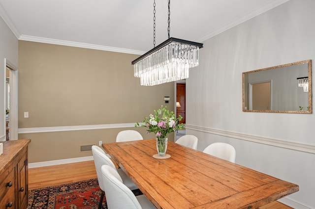 4803 Chantrey Pl, Minnetonka, MN 55345 - dining area with crown molding, wood finished floors, and a chandelier