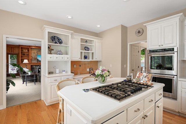 4803 Chantrey Pl, Minnetonka, MN 55345 - kitchen with appliances with stainless steel finishes, light wood finished floors, open shelves, light countertops, and white cabinetry
