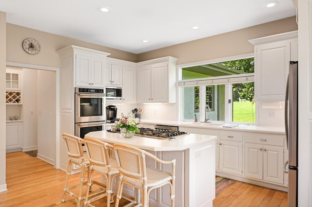 4803 Chantrey Pl, Minnetonka, MN 55345 - kitchen featuring stainless steel appliances, white cabinets, light wood-style flooring, and recessed lighting