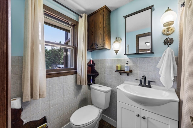 3322 277th Ave NW, Stanford Twp, MN 55040 - bathroom featuring tile walls, vanity, and wainscoting