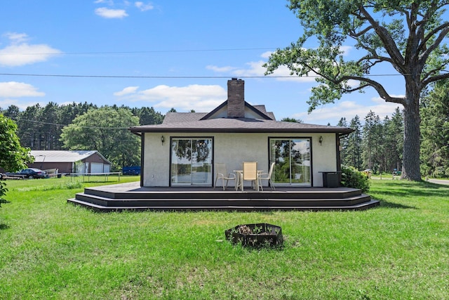 3322 277th Ave NW, Stanford Twp, MN 55040 - rear view of property with stucco siding, a deck, a lawn, and a chimney