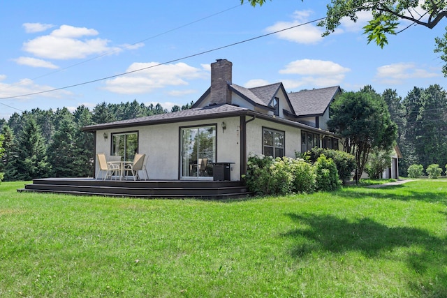 3322 277th Ave NW, Stanford Twp, MN 55040 - back of house with stucco siding, a wooden deck, a yard, a chimney, and a shingled roof
