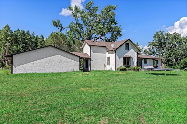 3322 277th Ave NW, Stanford Twp, MN 55040 - view of front of house featuring a trampoline, a front lawn, and stucco siding