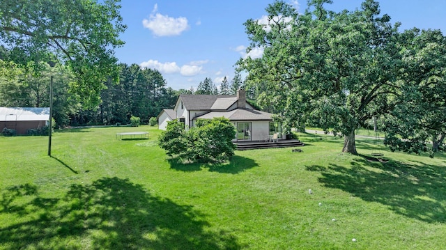3322 277th Ave NW, Stanford Twp, MN 55040 - view of grassy yard featuring a wooden deck and view of scattered trees