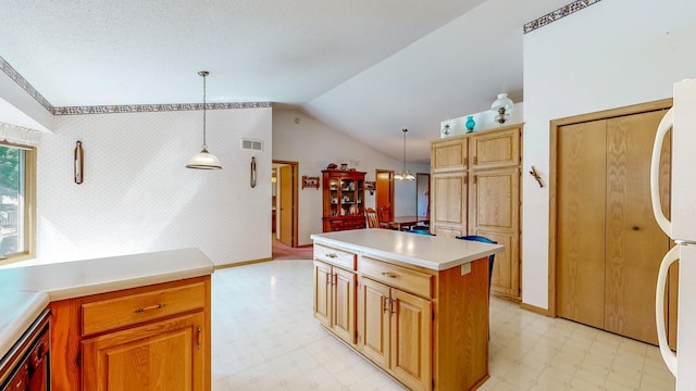 120 6th St SW, Chatfield, MN 55923 - kitchen featuring light floors, vaulted ceiling, fridge, light countertops, and pendant lighting