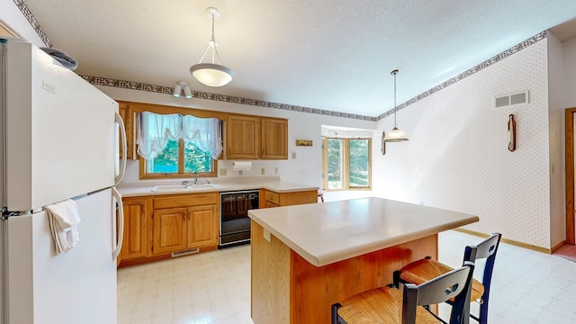 120 6th St SW, Chatfield, MN 55923 - kitchen with freestanding refrigerator, black dishwasher, light flooring, and healthy amount of natural light