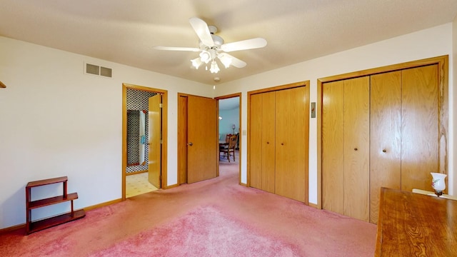 120 6th St SW, Chatfield, MN 55923 - unfurnished bedroom with two closets, carpet flooring, and a ceiling fan