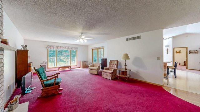 120 6th St SW, Chatfield, MN 55923 - living area with ceiling fan, a fireplace, a textured ceiling, and carpet