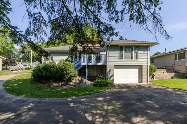 120 6th St SW, Chatfield, MN 55923 - view of front of property with driveway, stairway, an attached garage, a front lawn, and a wooden deck