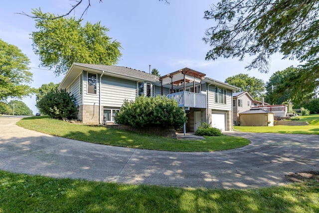 120 6th St SW, Chatfield, MN 55923 - view of front of property with asphalt driveway, a garage, a front yard, and a balcony