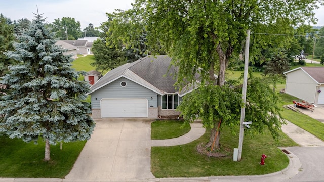 120 6th St SW, Chatfield, MN 55923 - view of front of house with concrete driveway, an attached garage, brick siding, and a front yard