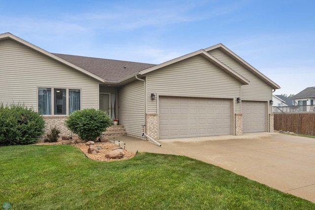 3437 26th Ave S, Fargo, ND 58103 - ranch-style house with brick siding, an attached garage, driveway, a front yard, and roof with shingles