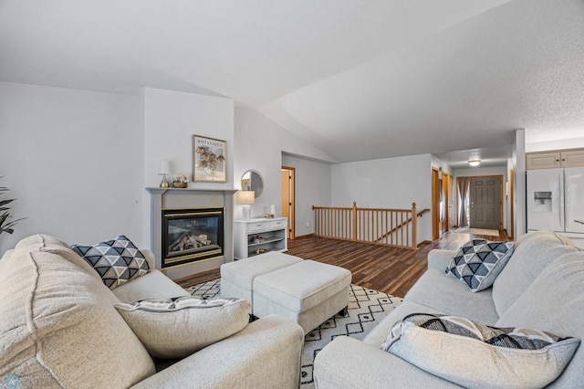 3437 26th Ave S, Fargo, ND 58103 - living room with wood finished floors, lofted ceiling, and a glass covered fireplace