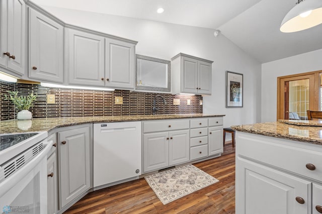 3437 26th Ave S, Fargo, ND 58103 - kitchen with white appliances, lofted ceiling, dark wood-type flooring, backsplash, and white cabinetry