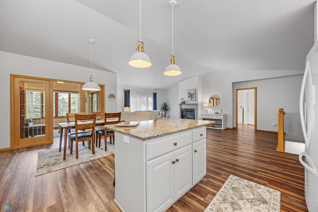 3437 26th Ave S, Fargo, ND 58103 - kitchen featuring vaulted ceiling, open floor plan, freestanding refrigerator, white cabinets, and healthy amount of natural light