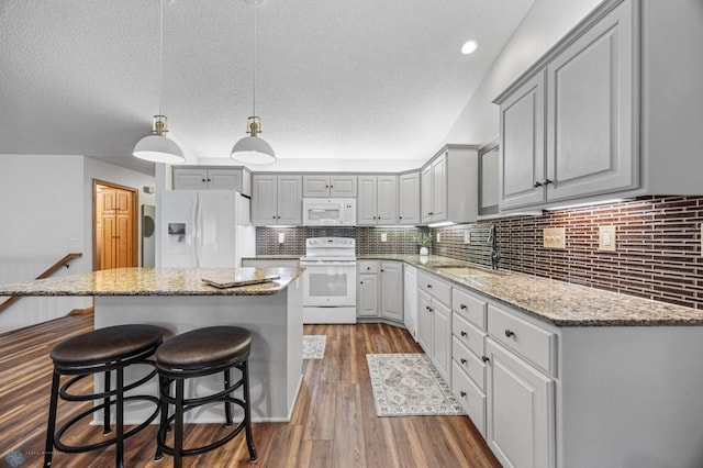 3437 26th Ave S, Fargo, ND 58103 - kitchen featuring white appliances, gray cabinets, a center island, dark wood-style floors, and a textured ceiling