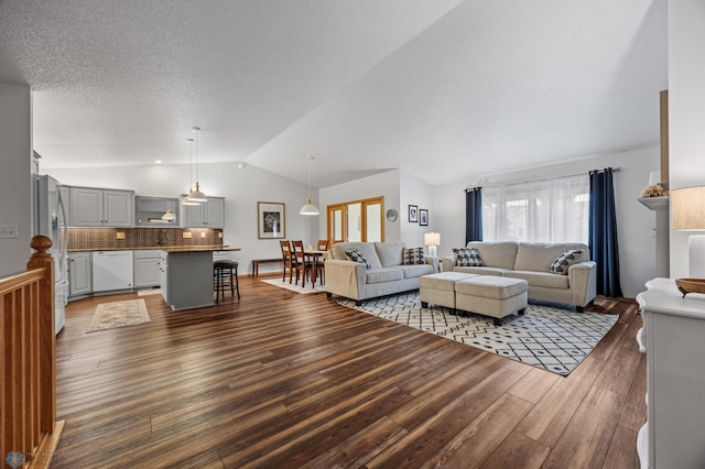 3437 26th Ave S, Fargo, ND 58103 - living room with dark wood-type flooring, lofted ceiling, and a textured ceiling