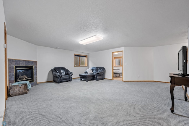 3437 26th Ave S, Fargo, ND 58103 - living area featuring a textured ceiling, carpet floors, and a tiled fireplace