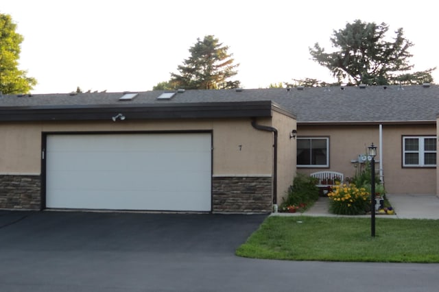912 3rd St N Unit 7, Cold Spring, MN 56320 - single story home featuring stone siding, stucco siding, driveway, and an attached garage