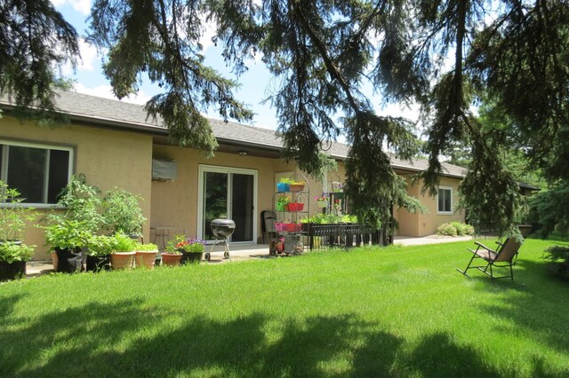 912 3rd St N Unit 7, Cold Spring, MN 56320 - back of property featuring stucco siding and a lawn