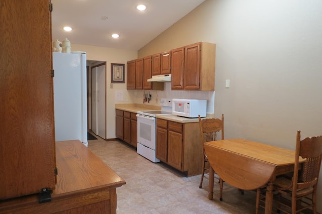 912 3rd St N Unit 7, Cold Spring, MN 56320 - kitchen with white appliances, under cabinet range hood, light flooring, lofted ceiling, and light countertops