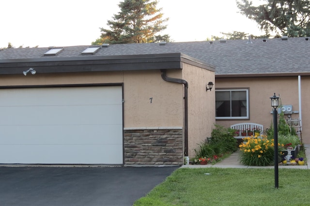 912 3rd St N Unit 7, Cold Spring, MN 56320 - view of property exterior featuring a shingled roof, stone siding, stucco siding, and driveway
