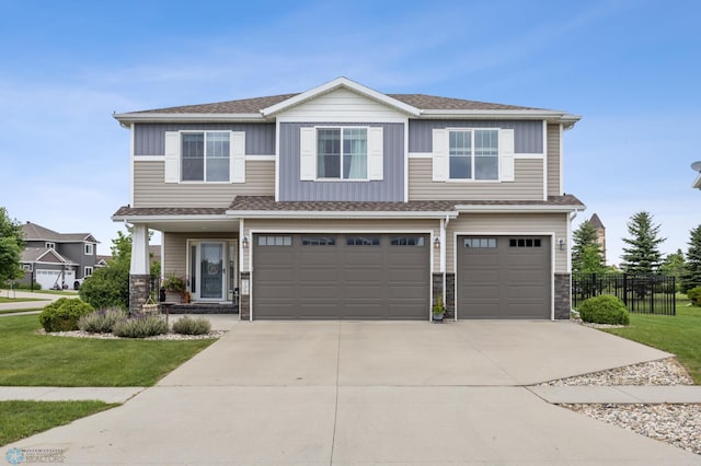 708 30th Ter E, West Fargo, ND 58078 - view of front of property featuring an attached garage, driveway, stone siding, and board and batten siding