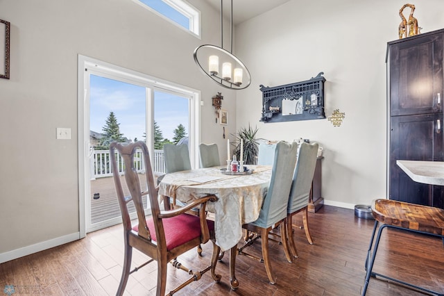 708 30th Ter E, West Fargo, ND 58078 - dining area featuring a chandelier, wood finished floors, and a towering ceiling