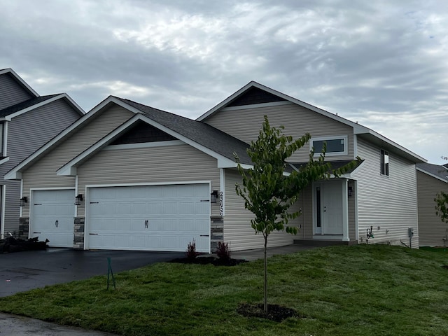 23648 Lily St NW, Saint Francis, MN 55070 - view of front of home with a front yard, asphalt driveway, and a garage