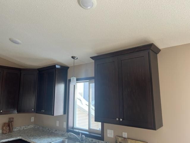 23648 Lily St NW, Saint Francis, MN 55070 - kitchen with a textured ceiling, pendant lighting, and light stone countertops