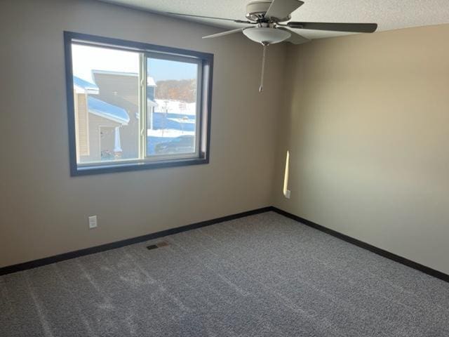 23648 Lily St NW, Saint Francis, MN 55070 - empty room with ceiling fan, carpet flooring, and a textured ceiling