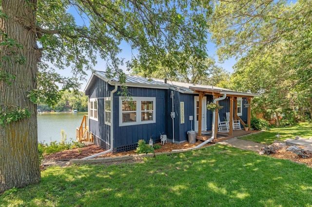 13491 80th St NW, Annandale, MN 55302 - view of front facade featuring a water view, a front yard, and board and batten siding