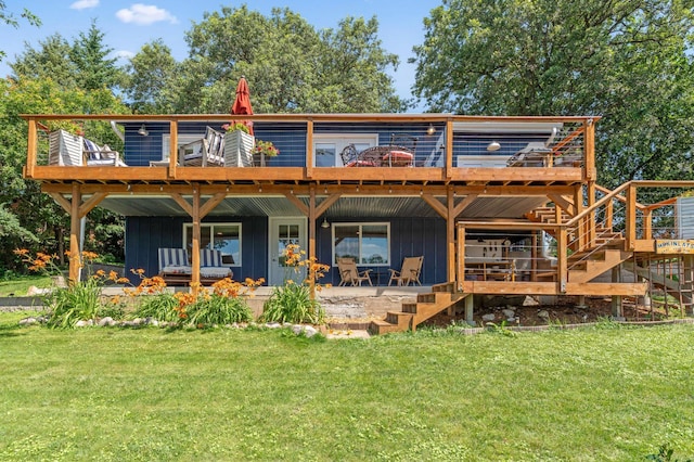 13491 80th St NW, Annandale, MN 55302 - back of house with board and batten siding, a lawn, and a wooden deck
