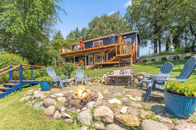13491 80th St NW, Annandale, MN 55302 - back of house with an outdoor fire pit, a deck, stairway, and a lawn