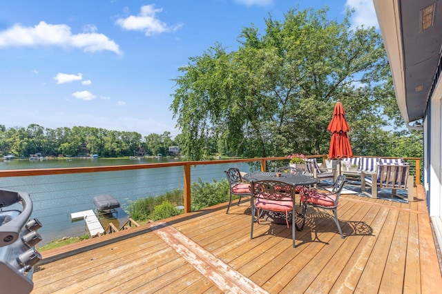 13491 80th St NW, Annandale, MN 55302 - wooden deck featuring a water view and outdoor dining space