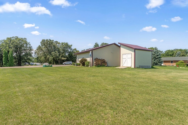 13491 80th St NW, Annandale, MN 55302 - view of grassy yard featuring a detached garage and an outdoor structure