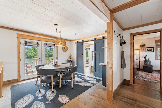 13491 80th St NW, Annandale, MN 55302 - dining space with a barn door, ornamental molding, hardwood / wood-style flooring, and french doors