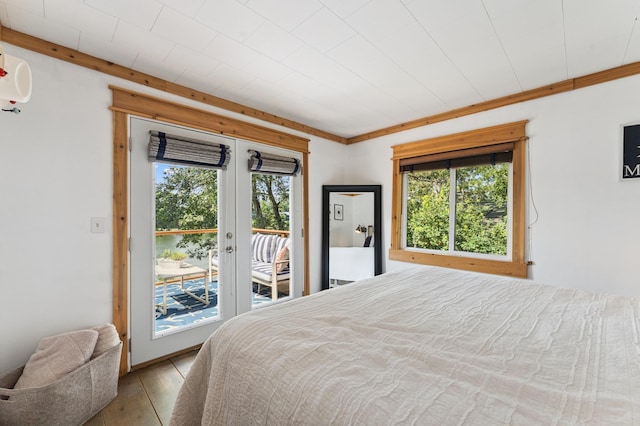 13491 80th St NW, Annandale, MN 55302 - bedroom featuring multiple windows, access to outside, hardwood / wood-style flooring, french doors, and crown molding